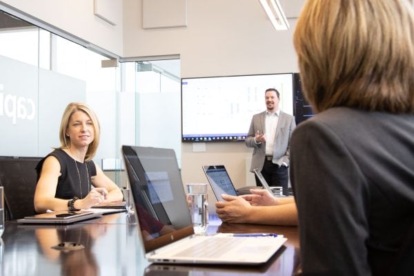 High-level business meeting with professionals in a modern conference room at Capital Data.